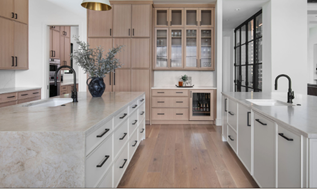 Soft white kitchen island with warm wood perimeter cabinets. Black hardware on all cabinets.